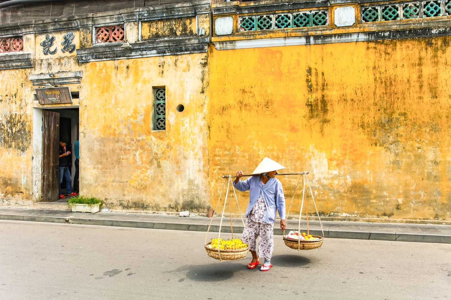 woman seller hoi an vietnam shutterstock 1093155044