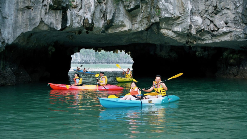Halong Bay Cruise Overnight: A Timeless Journey Through Vietnam’s Iconic Seascape 5 Travelers kayaking through hidden lagoons on a Halong Bay cruise overnight
