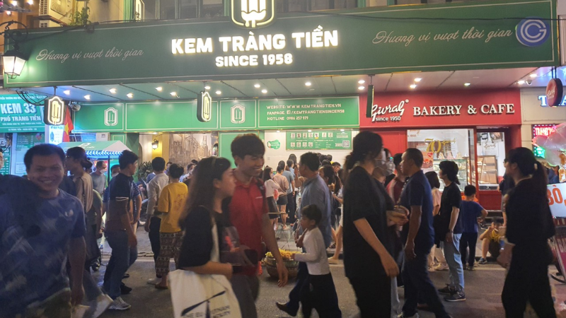 People enjoying Trang Tien ice cream outside the famous Hanoi ice cream shop
